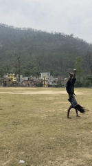 Person performs backflips, poses by river in Chisapani Nepal