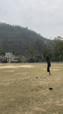 Person performs backflips, poses by river in Chisapani Nepal