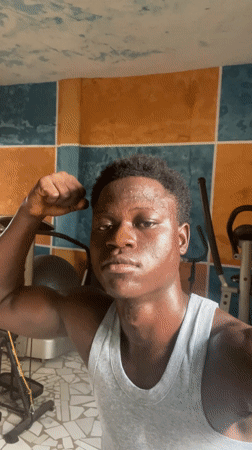 Man films workout poses in colorful home gym