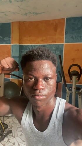 Man films workout poses in colorful home gym