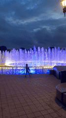 Illuminated fountain lights up a Moscow park at dusk