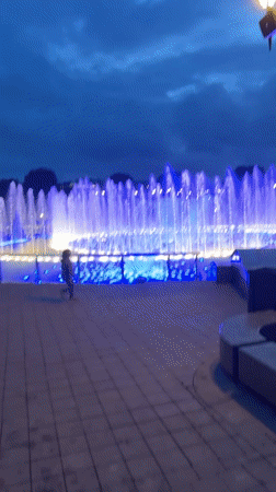 Illuminated fountain lights up a Moscow park at dusk