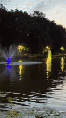 Illuminated fountains glow at dusk in Kraków