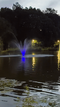 Illuminated fountains glow at dusk in Kraków