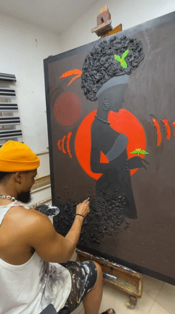 Artist paints on large canvas in Ado workspace