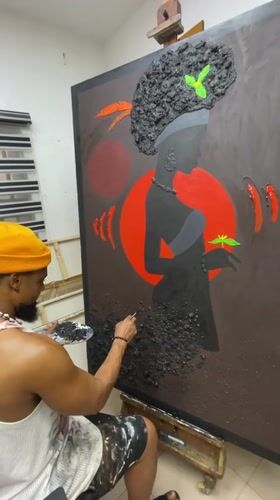 Artist paints on large canvas in Ado workspace