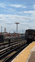 NYC subway rolls past Coney Island's rides and towers