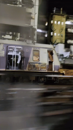 Mumbai local train 2097C passing a station at night