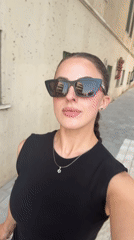 Woman walks Tel Aviv street wearing Star of David necklace
