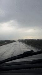Vehicle drives through wet conditions in Belgrade suburb
