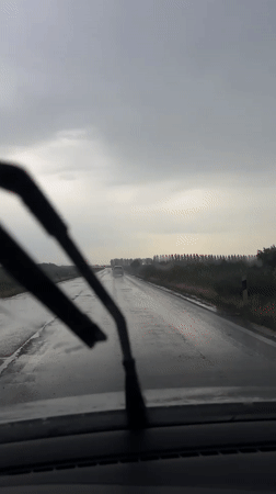 Vehicle drives through wet conditions in Belgrade suburb