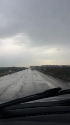 Vehicle drives through wet conditions in Belgrade suburb