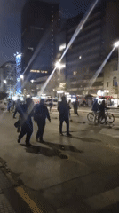 Nighttime march with banners and riot police in Santiago