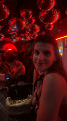 Evening social scene captured at red-lit Dubai nightclub