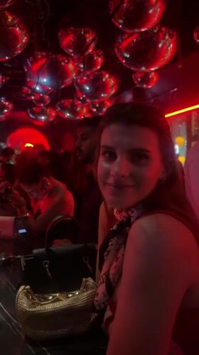 Evening social scene captured at red-lit Dubai nightclub
