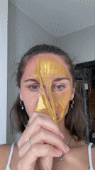 Woman removes gold face mask in Sochi beauty routine