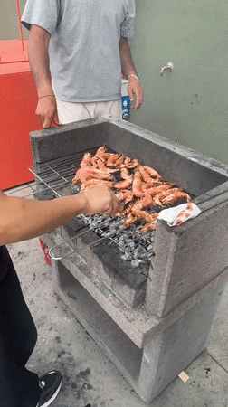 Rooftop shrimp barbecue gathering documented in Turin