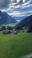 Cable car riders document scenic Swiss alpine valley views