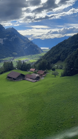 Cable car riders document scenic Swiss alpine valley views