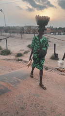 Two people spotted on deteriorating road in Ikire at sunset