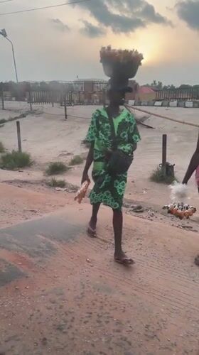 Two people spotted on deteriorating road in Ikire at sunset