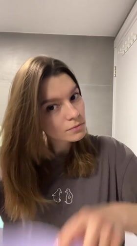 Woman completes evening bathroom routine in Limassol, Cyprus