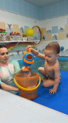 Child plays with water toys at Russian swimming pool