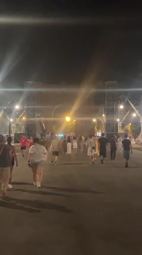 Late-night crowd gathers at lit Barcelona archway, jerseys and all