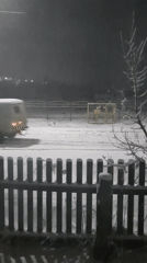 White van drives through heavy snowfall in Krasnogorskoye