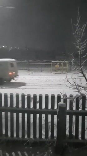 White van drives through heavy snowfall in Krasnogorskoye