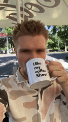 Man enjoys coffee with custom mug in Tashkent