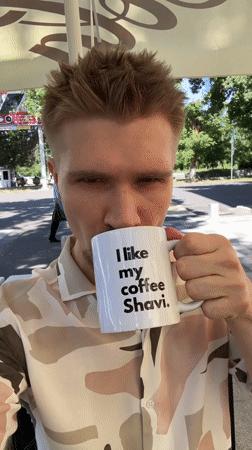 Man enjoys coffee with custom mug in Tashkent