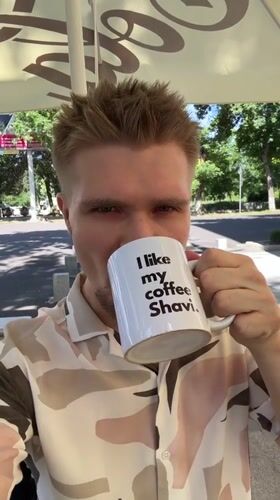 Man enjoys coffee with custom mug in Tashkent