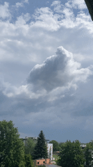 Urban observer documents approaching storm clouds from balcony