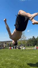 Man performs backflips and handstands in sunny park