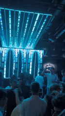 Nightclub revelers dance under blue lights in Sofia