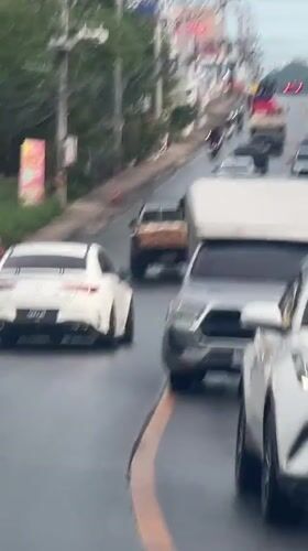 Traffic flows on wet streets in Baan Bo Phut