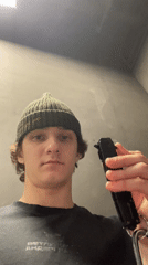 Young man displays folding knife indoors in Krasnoyarsk