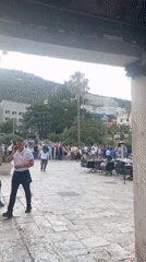 Traditional folk dancers perform for crowds in Budva square