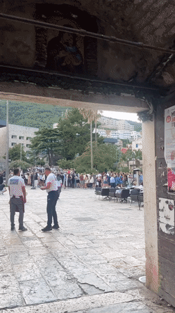 Traditional folk dancers perform for crowds in Budva square