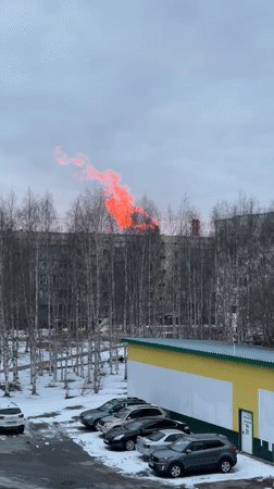 Bright red cloud observed rising behind building in Surgut