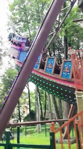 LED-lit Viking ship pendulum ride in full swing, Perm
