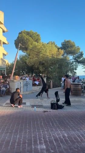 Breakdancer performs handstand routine for crowd in Peguera