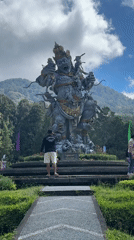 Afternoon out at a Baturiti temple park with statues and a puppy