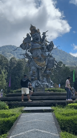 Afternoon out at a Baturiti temple park with statues and a puppy