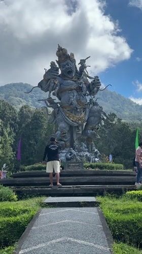 Afternoon out at a Baturiti temple park with statues and a puppy