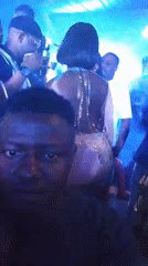 Person films inside blue-lit crowded club venue