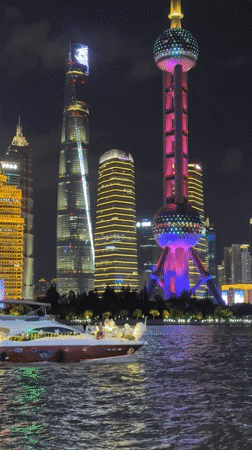 Yacht cruise along the Shanghai skyline at night