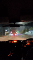Night drive through Meger streets, dashboard lit, trailing traffic.