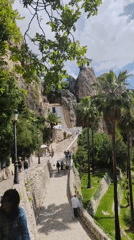 Tourists explore historic clifftop castle grounds in Guadalest, Spain